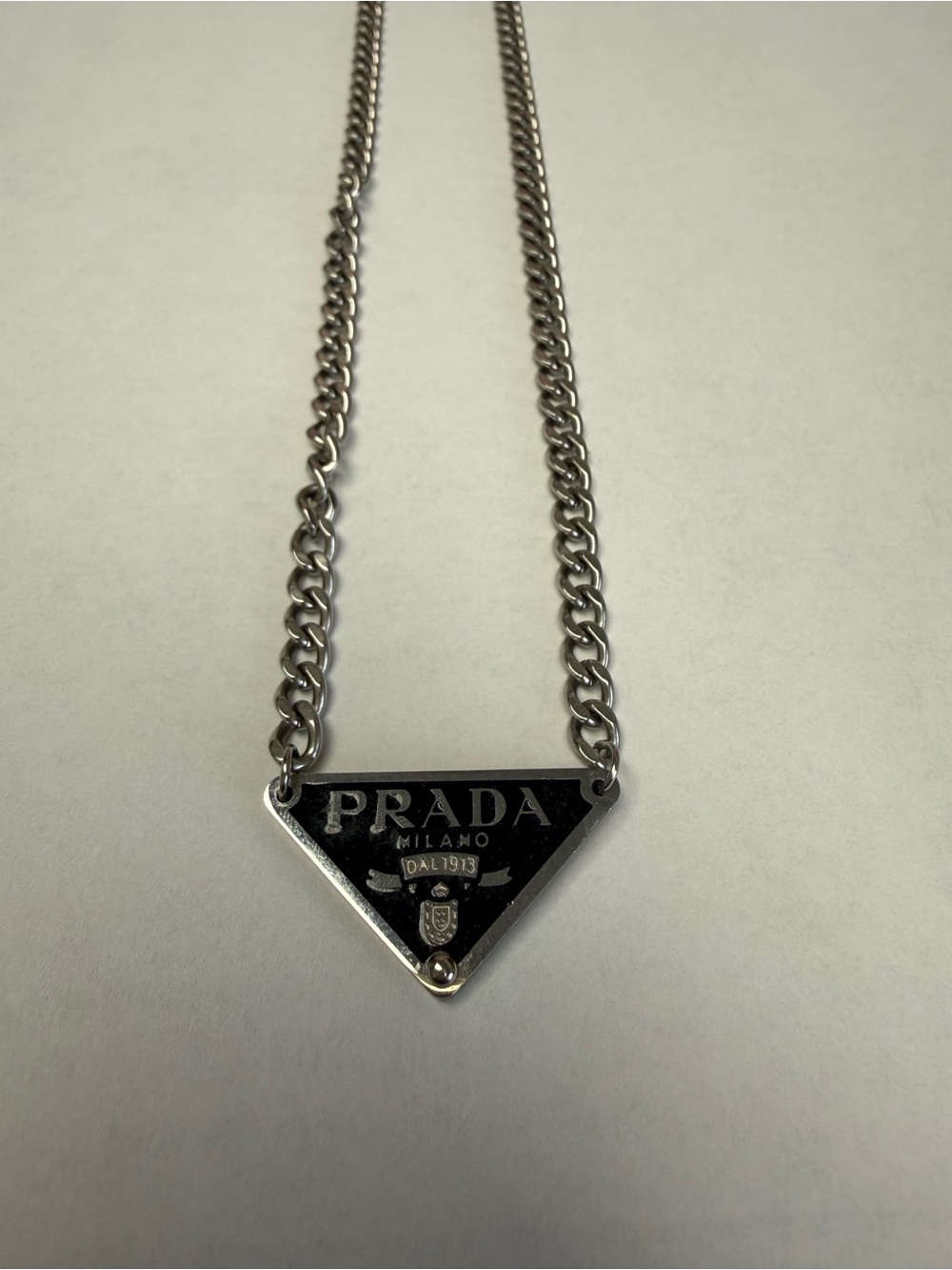 PlBlack and Silver Triangle Logo necklace